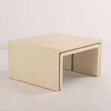 Sold at Auction: NEST OF THREE PARCHMENT COVERED TABLES IN THE MANNER OF JEAN-MICHEL FRANK.