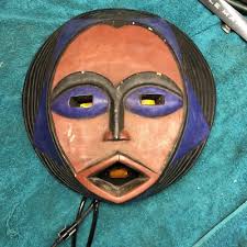 African voodoo mask head with illuminated eyes and mouth ...