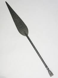 Sold at Auction: A tribal staff or paddle, the elongated tapered oval blade carved with styl