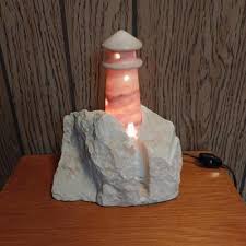 WOODEN THREE DRAWER CABINET AND STONE LIGHTHOUSE LIGHT ...