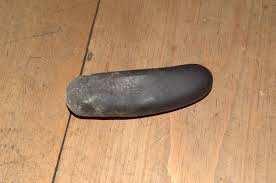 A stone pestle on the floor of a rural house in Bhutan ...