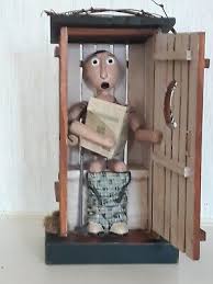 Out House comical figure inside reading a newspaper ...