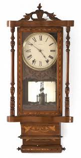 Lot - NEW HAVEN WALL REGULATOR CLOCK in walnut case with select wood inlays. Carved upper crest in pineapple form. Height 35.5".
