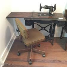 Lot 43 - Antique Royal Sewing Machine in Table & Rolling Office Chair | EstateSales.org