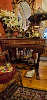 What was this table used for? A friend owns this antique piece but knows nothing of the origin or what it was used for. The top is solid black glass, and it