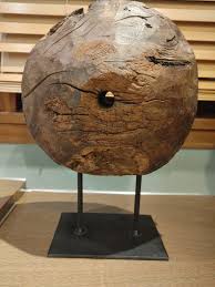 An Antique Wooden Pulley on a metal base