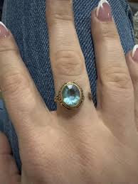 Looking to identify the purple stones besides the garnet ...