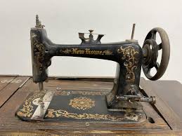 Sold at Auction: Vintage New Home Sewing Machine On Casters