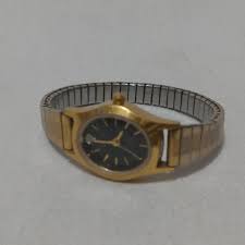 Armitron Womans Watch is Gold Tone. It has a black... | Depop