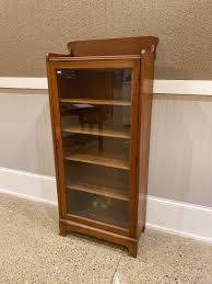 Sold at Auction: Oak single door bookcase, 26” x 12” x 57”