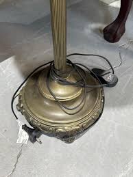 Sold at Auction: Floor lamp with Leadlight shade, metal base, column form, takes two light globes, fitted with in-line foot switch. 165 cm high, shade, 44 cm diameter.