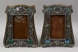 Lot - PAIR OF MATCHED BIRMINGHAM SILVER AND ENAMEL ART NOUVEAU STYLE PICTURE FRAMES