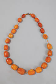 Sold at Auction: Collier de 22 perles d'Ambre.