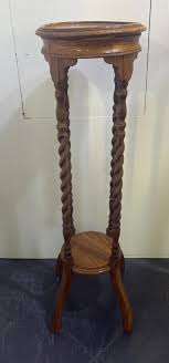 At Auction: A Pair of Oak Jardine Stands with Twist Detail