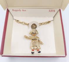EMMONS GOLD TONED RAGGEDY ANN NECKLACE | EstateSales.org
