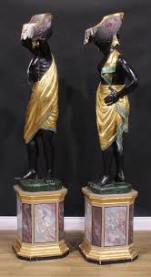 Sold at Auction: A pair of Venetian parcel-gilt and polychrome painted blackamoor torcheres, each carved as a Nubian attendant, canted square plinth bases, 186cm high