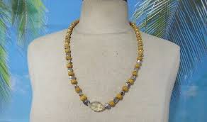Necklace with Yellow Wood Beads, Silver Tone Beads, and a ...