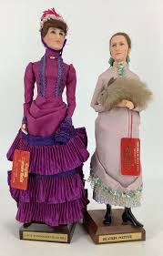 Lot - (2) Ann Parker English costume dolls, Lady Randolph Churchill and Beatrix Potter. 12" and 11 1/2" tall including stands, mohair wigs, molded and painted facial features, one-piece head/torso/legs with wire