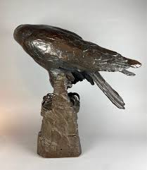 A life size terracotta bronze coloured sculpture of an eagle ...