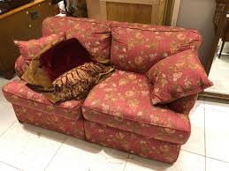 Sold at Auction: Red floral upholstered sofa and loveseat.