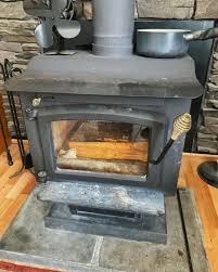 What is the purpose of the piece sticking out of the wood stove?