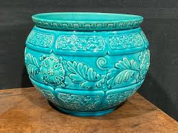 A Burmantofts Faience jardiniere, relief moulded with stylised ...