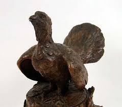 Lot - A BLACK FOREST CARVED AND STAINED RUFFED GROUSE-FORM TOBACCO JAR