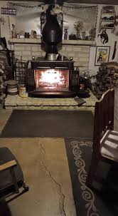 Franklin stove in attached shop for greenhouse warmth