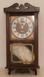 Lot - Centurion 35 day wood case wall clock