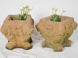 20th-century pair of square concrete planters w/ lions & terracotta pa
