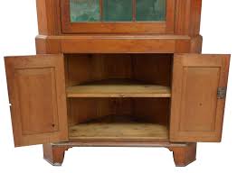 Lot - +Corner cabinet, American, late 18th/19th C., cherry, pine second, in two parts, flat molded top over single twelve lite mullioned door with old glass centering flute shaped pilasters, interior with
