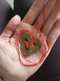 3 gold/copper coloured discs tied together with red string in a red enevlope. What is it? : r/whatisthisthing