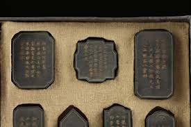Lot - A CASED SET OF TEN INK CAKES WITH LANDSCAPES, CHINESE, POSSIBLY HONGXIAN PERIOD (1915-1916), EARLY 20TH CENTURY, Obelisk: 3 3/4 x 1 1/2 x 0 3/8 in. (9.5 x 3.8 x 1 cm.)