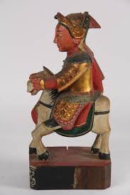 Lot - NEPALESE WOOD CARVING - Late 19th c. Figure of a Warrior on Horseback, in polychrome, with gilding and moriage, on an integral base, 12 1/2" x 6" x 4 1/2".