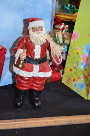 Standing Santa figure holding a bell with glasses and bag of ...