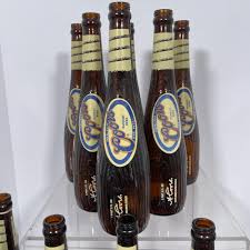 Sold at Auction: Eighteen Limited Edition Coors Bat Bottles, Eighteen 18oz Coors "Banquet Beer" Bottles styled as baseball bats, with eighteen corresponding loose caps. In two original illustrated cardboard display boxes designed