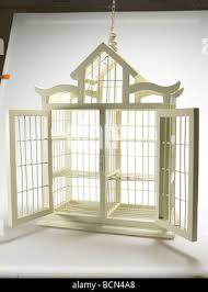 Decorative white bird cage full of pink roses. Candy Bar Stock Photo - Alamy