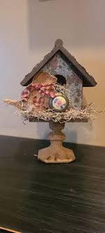 I made this rustic birdhouse with a candle stick glue on it.