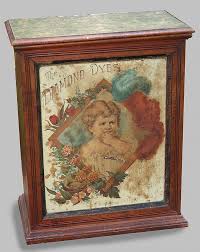 Lot - "DIAMOND DYES" COUNTER DISPLAY CABINET In walnut with tin lithographed front depicting a child with flowers and bird's nest, inscrib..