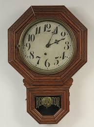 Lot - SCHOOLHOUSE REGULATOR CLOCK - Oak Cased, with ocatgonal frame around dial, "Regulator" in gold on lower glass, circa 1910, by Ingraham Clock Co, Bristol, Conn (marked along bottom of dial).