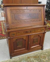 Lot - A VICTORIAN WALNUT DROP-FRONT SECRETARY, Charles Eastlake design, American, c. 1885, the fall front desk surmounting a double-door cabinet with drawer. Dimensions: 47.5"H x 37.5"W x 18"D.