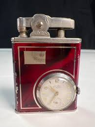 Sold at Auction: Eclydo German made lighter and timepiece ...
