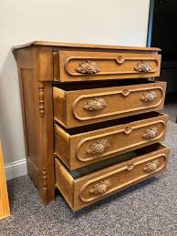 Sold at Auction: Five Drawer Walnut Dresser with Carved Pulls