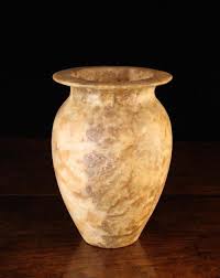 Sold at Auction: An Egyptian Alabaster Canopic Urn, 9'' (23 cm) in height.