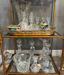 ✨💎 Crystal Clear Intentions 💎✨ When the light hits just right, this golden bamboo shelf becomes a stage for pure brilliance. The top tier gleams with cut crystal vases, decanters, and candlesticks