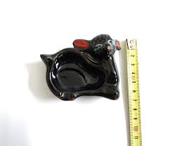 A ceramic masterpiece of the little black cat, approximately ...