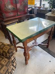 Remarkable vintage 1950 enamel top light green table with two sides $75.00. Closed it measures 40” wide x 25”, with one side up it's 36” x 40”, and with both sides up