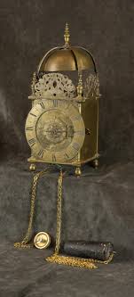 Lot - AN ENGLISH BRASS STRIKING LANTERN CLOCK WITH ALARM