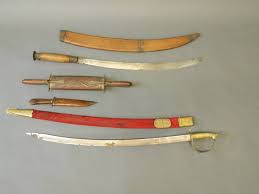 An Indian Sword, Two Knives, And An Eastern Curved