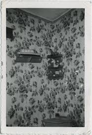 TCHOTCHKES DISPLAYED on SHELVES in CORNER BUSY FLORAL WALLPAPER